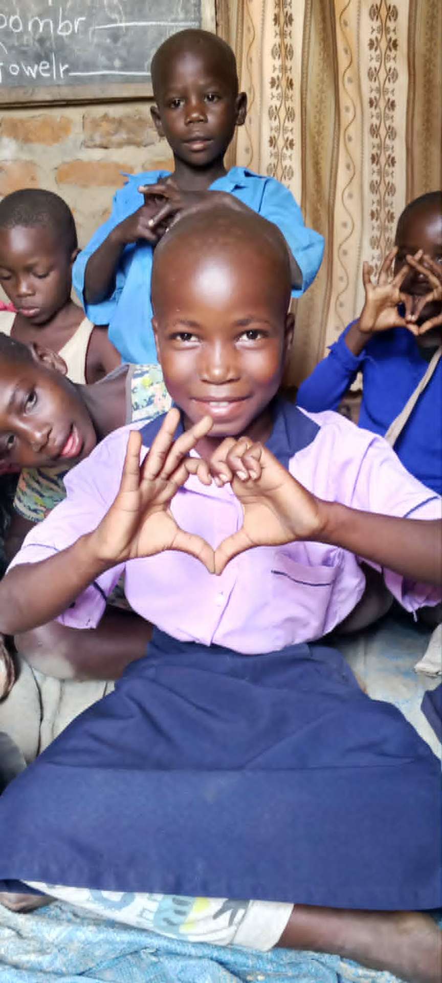 Children forming a heart with their hands